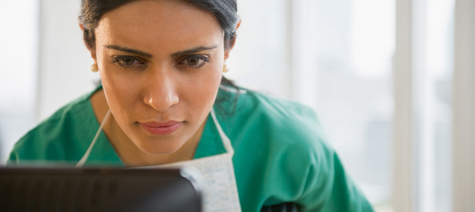 healthcare worker looking on a screen