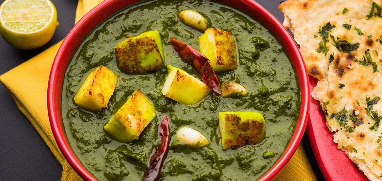 Indian curry dish - Palak paneer made up of  spinach and cottage cheese, served in white bowl, selective focus