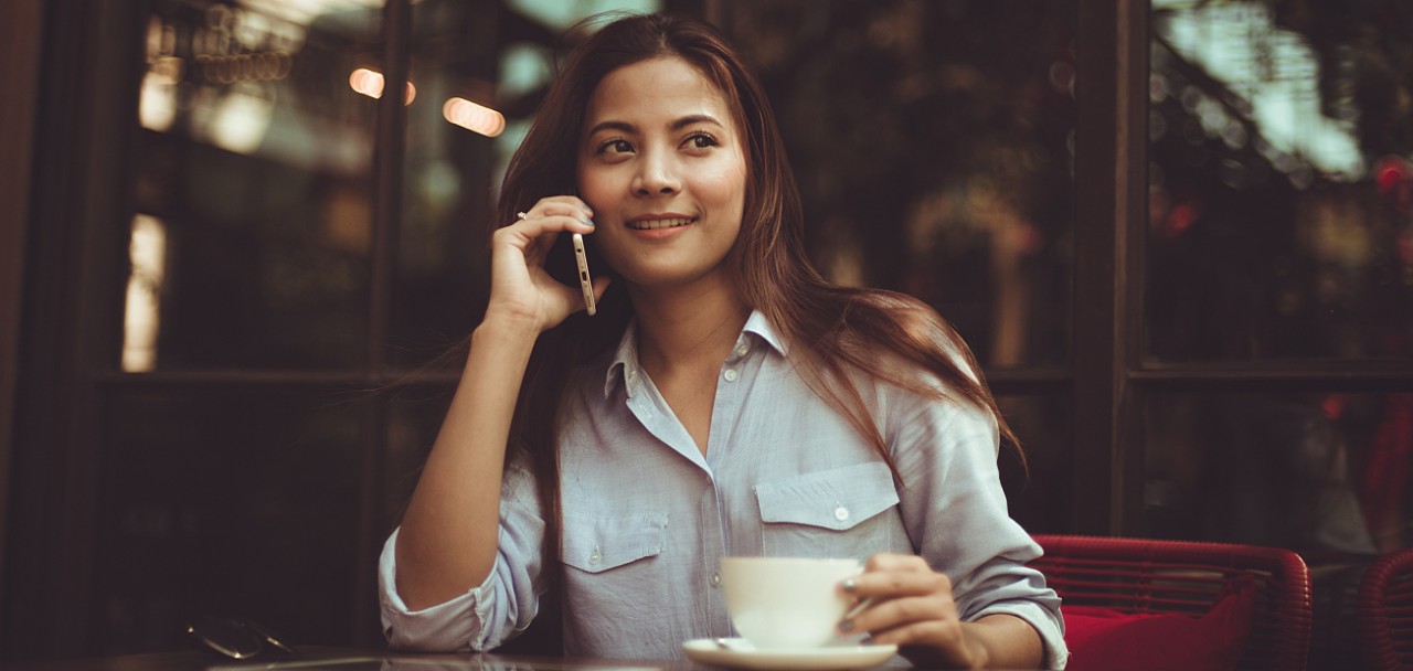 Asian woman drinking coffee in vintage color tone