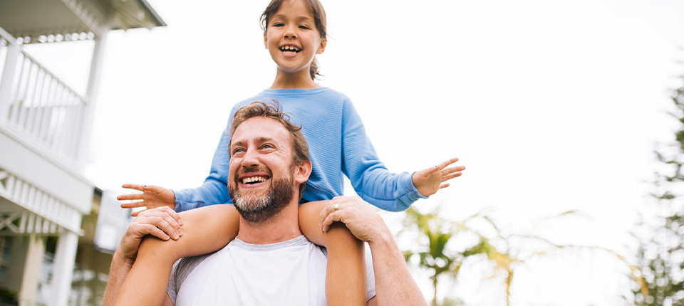 man carrying a kid on his shoulder