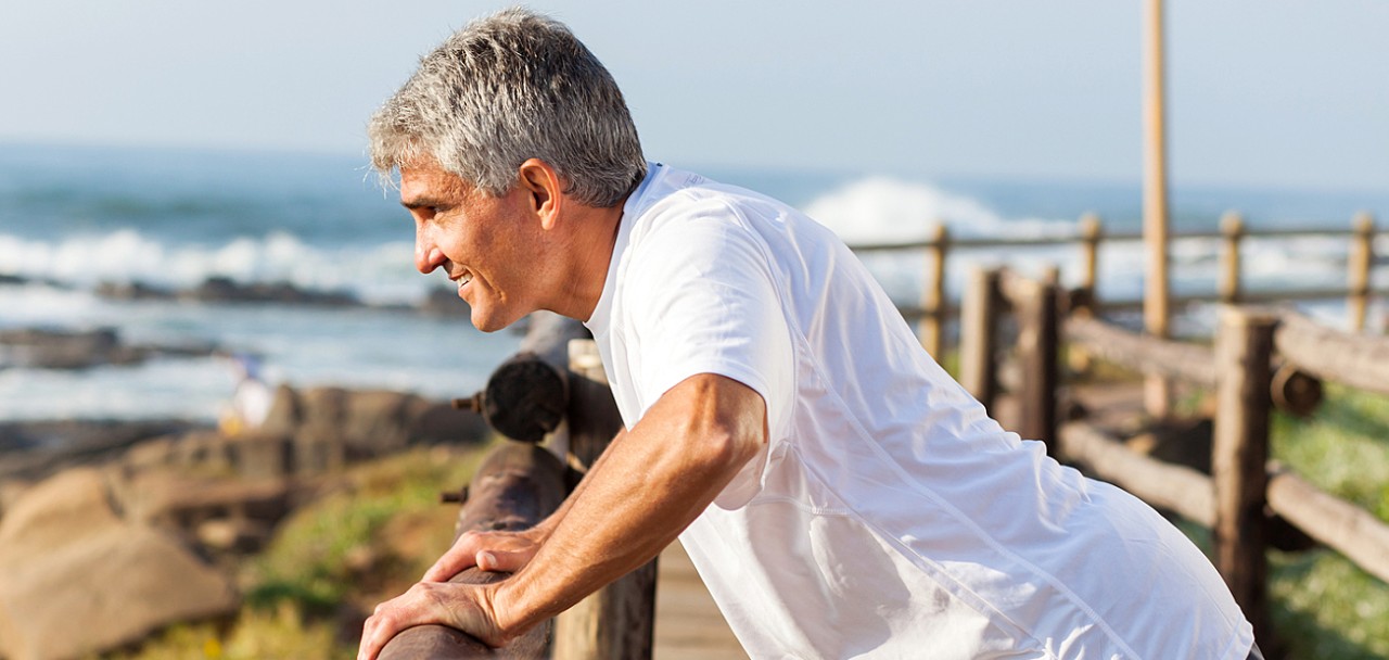 fit senior man exercising at the beach in the morning