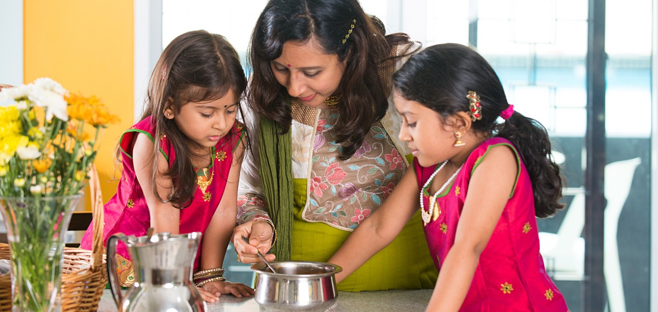 indian mother cooking with her daughters at kitchen; Shutterstock ID 331438631; PO: 123