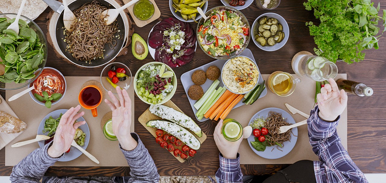 Various vegan and vegetarian food lying on rustic table