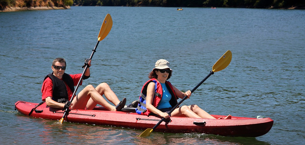 A middle age couple kayaking on the lake